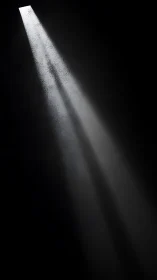 Single beam of light slices through deep cinematic darkness