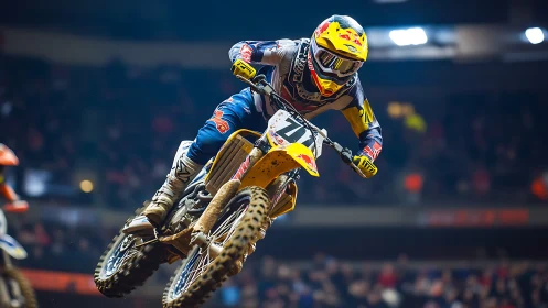 Stadium dirt rider launches into roaring floodlit air.