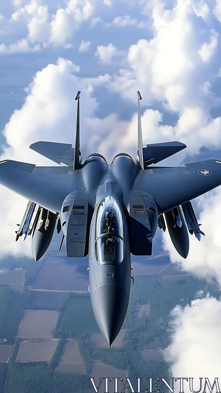 Tactical jet fighter in high-altitude pass above clouds.