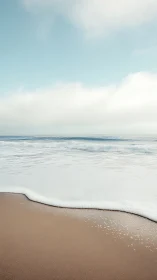 Minimalist shoreline photograph with soft atmospheric depth.