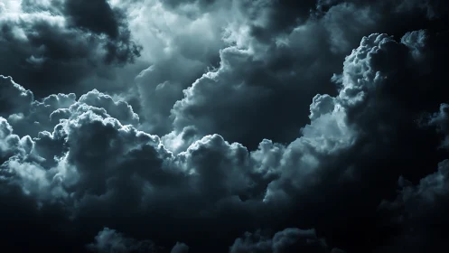 Moonlit storm clouds gather in a dramatic night sky.
