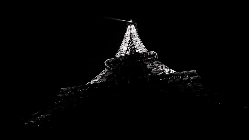 Illuminated lattice tower captured from low angle at night