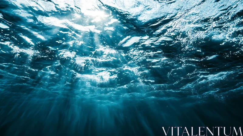 Sunlit underwater waves with radiant blue light beams.