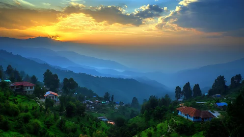 Mountain valley village under layered blue ridges at sunset