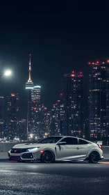 Sporty white coupe glowing softly against city night lights.