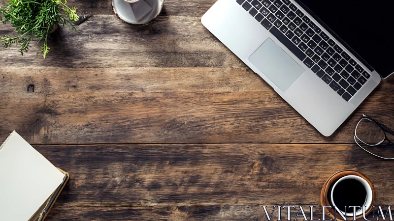 Overhead optical study of laptop workspace on rustic desk.