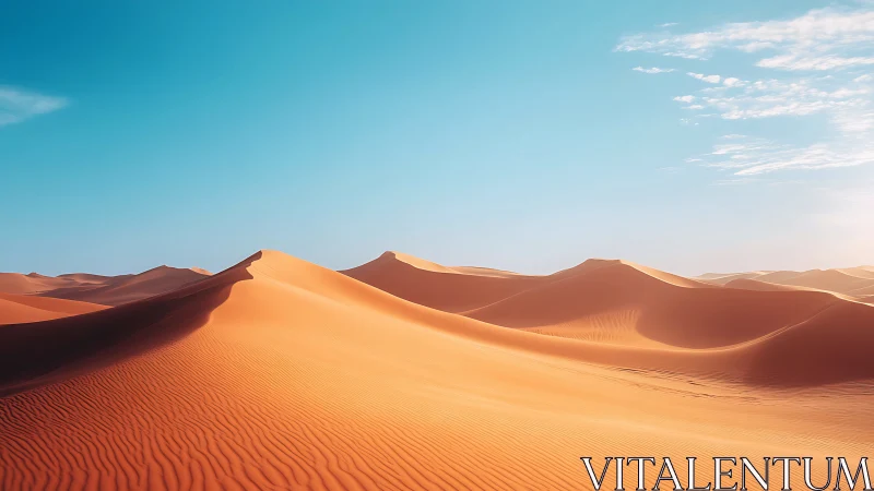 Sunlit desert dunes under clear cyan sky at golden hour.