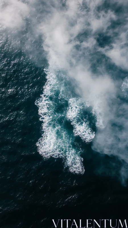 Ocean mist drifting over midnight teal waves at dawn.