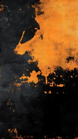Orange paint splatter over distressed black canvas surface.