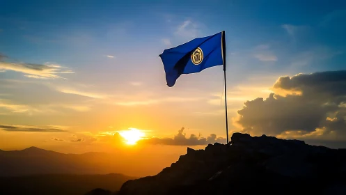 Blue institutional flag silhouettes against a dramatic alpine sunset