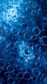 High-contrast macro view shows refractive air bubbles in blue liquid