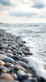 Shallow depth field shoreline pebbles with soft incoming waves