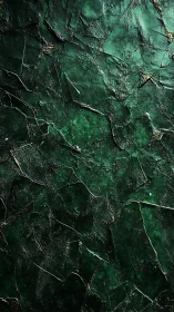 Dark green cracked textured surface with rough highlights.
