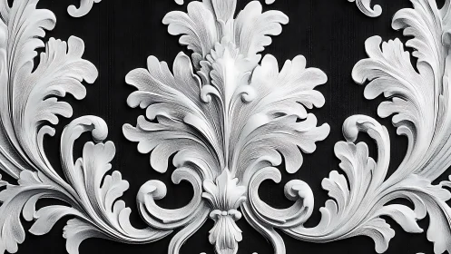 Symmetrical silver acanthus relief on black background.