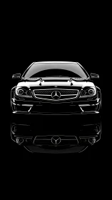 Black performance coupe front view with mirror reflection