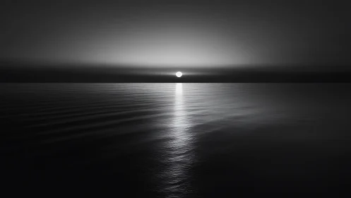 Monochrome seascape records sun aligned on distant horizon