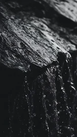 Midnight cascade murmuring over glistening stone edges.