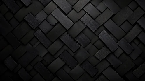 Interlocking matte black rectangular tiles form woven geometric relief