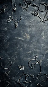 Ornate dark floral scrollwork over textured stone surface.