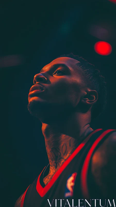 Basketball player portrait under dramatic arena lighting.