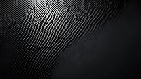 Dark metallic texture ripples across a diagonal light field