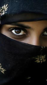 Close-up portrait of covered face with intense brown eyes.