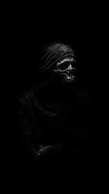 Hooded skull figure emerging from deep black shadows.
