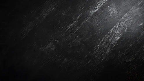 Black textured surface shows diagonal light streak patterns