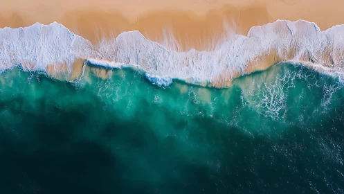 Aerial shoreline with turquoise surf and golden sand gradient