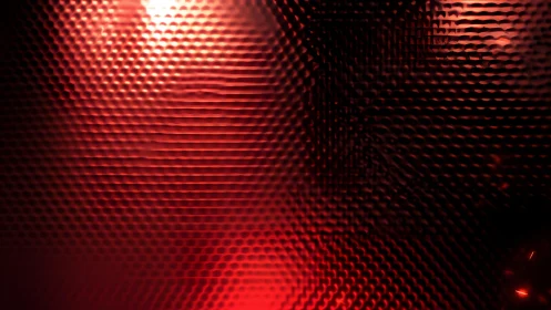 Abstract red glass texture with honeycomb pattern and light.