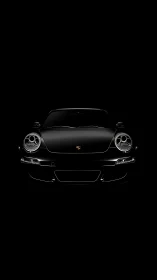 Black sports car front view on dark isolated backdrop.