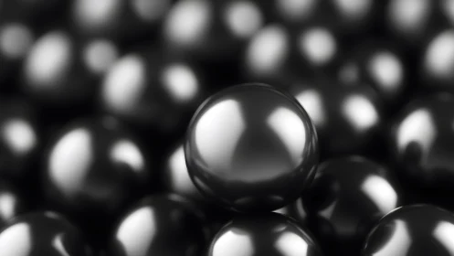 Gleaming black spheres gathered in a soft metallic drift.