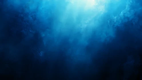 Deep blue underwater light rays penetrate dense ocean haze