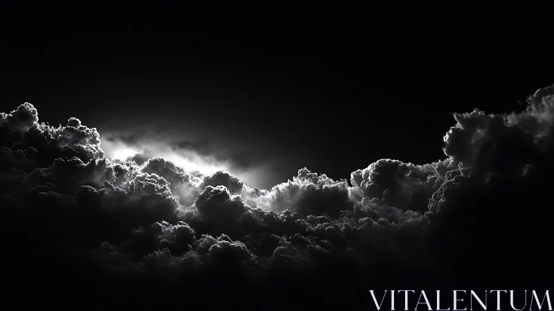 Backlit cumulonimbus cloud bank in monochrome night sky.