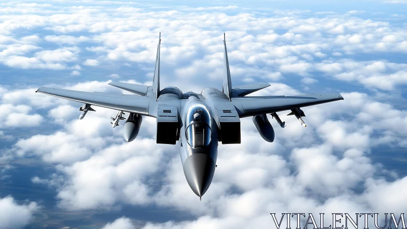 Modern gray fighter jet flying above dense white clouds.