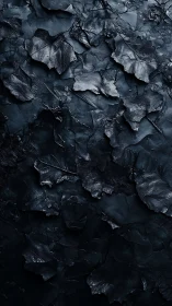 Dark metallic leaf textures form a moody abstract surface.