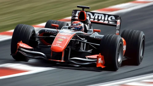 Formula racing car on track in front-facing motion view.