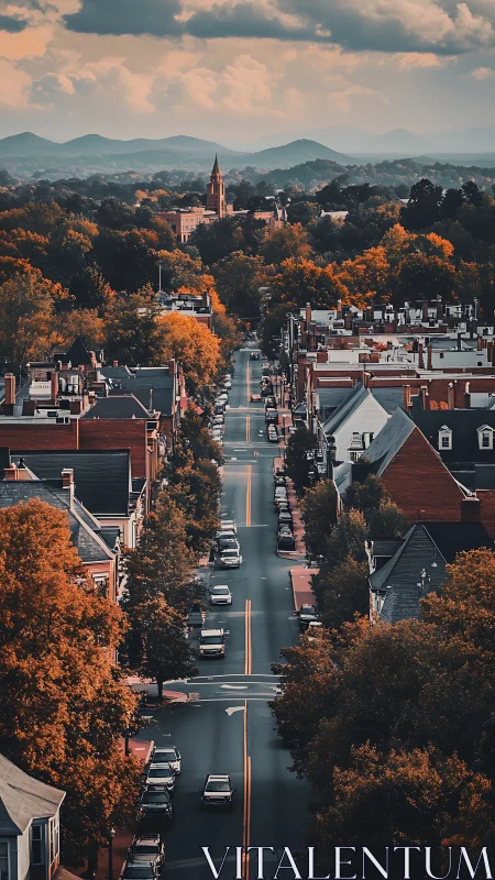 Autumn city avenue leads toward distant mountain horizon.