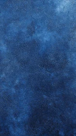 Dense ultramarine textured surface reveals layered pigment depths
