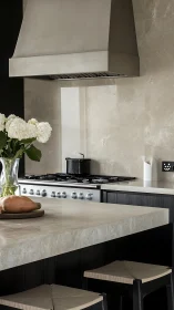 Minimalist stone kitchen with stainless range hood and island