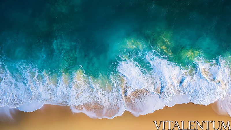 Aerial view of turquoise ocean surf meeting sandy shoreline.