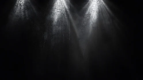 Spotlights cut through darkness over a textured black wall