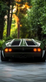 Low-slung green wedge supercar with quad exhaust and rear LED lamps