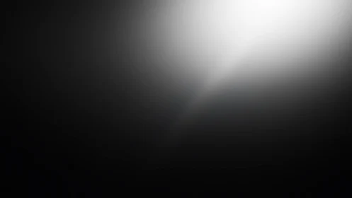 Radial white spotlight gradient dissolves into deep black field