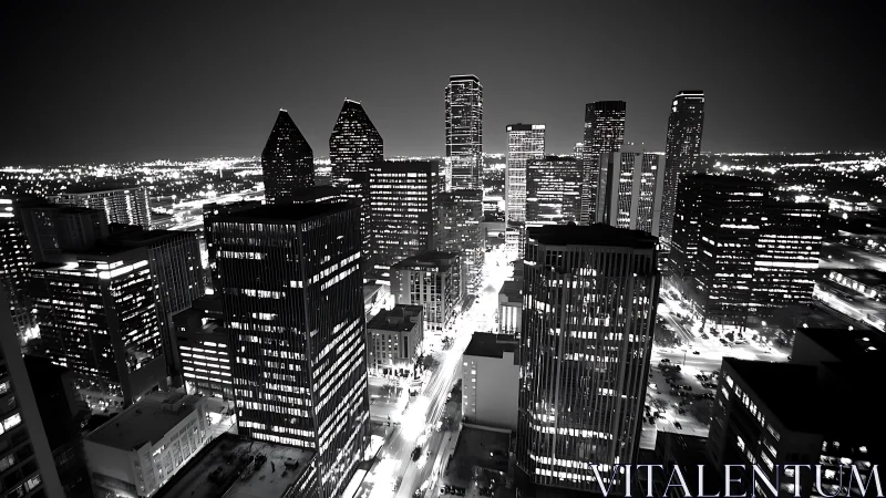 Monochrome aerial view records illuminated urban high‑rise core