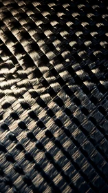 Carbon fiber textile closeup shows reflective woven strands