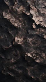 Charred canyon skin of midnight rock, brushed by ember light.