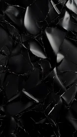 Fragmented glossy black surface forms irregular broken pattern