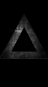 Rough metal triangle symbol on dark black background.