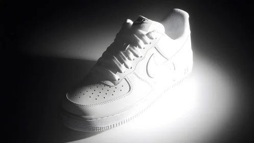 Classic white Nike Air Force 1 sneaker in dramatic studio lighting.